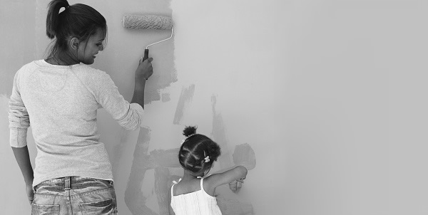 Mother and daughter painting a wall together as they renovate their home
