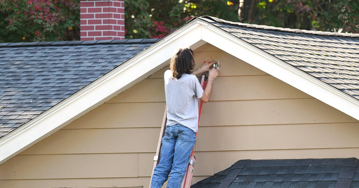person working on outside of home