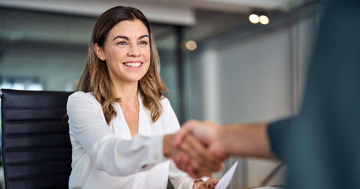 woman shaking another persons hand