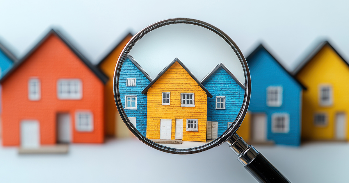 magnifying glass over house figures