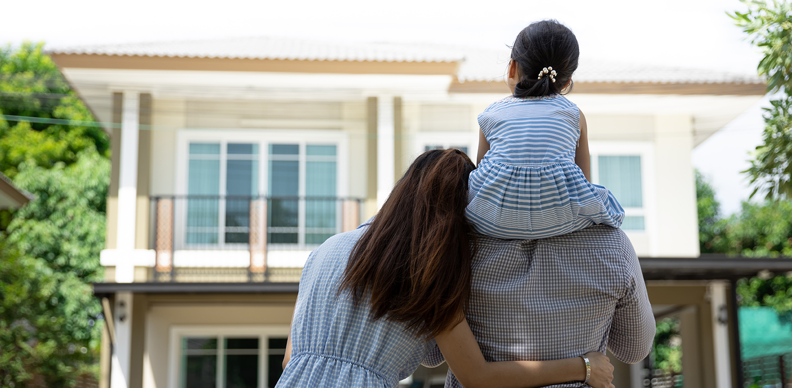 family looking at home in front of them