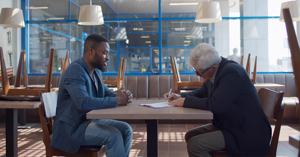 business owner meeting with retirement planner in cafe