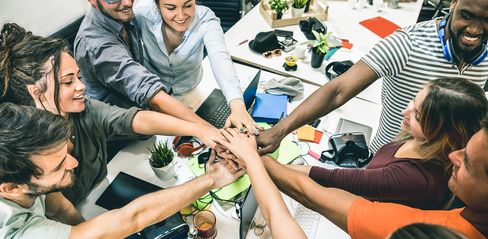 team putting hands in a group