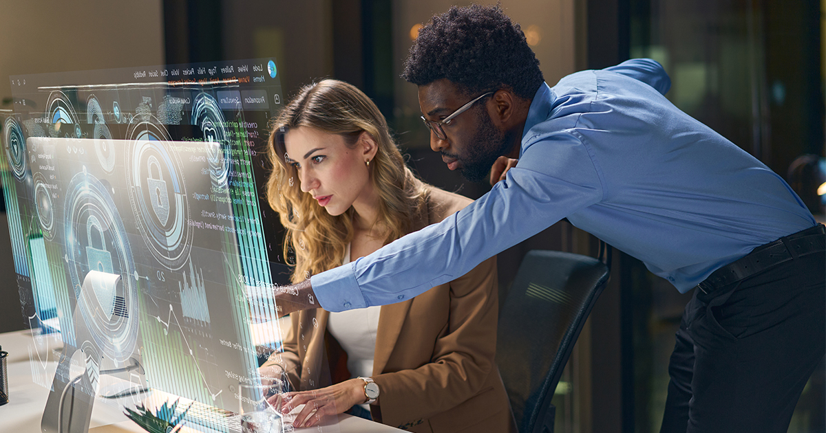 two people looking at computer with security symbol