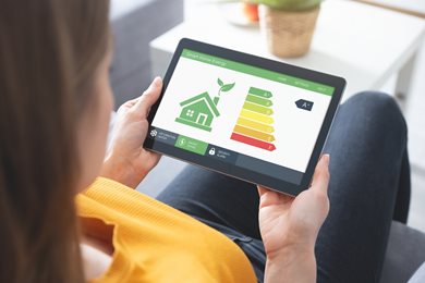 woman looking at home energy assessment results on a tablet