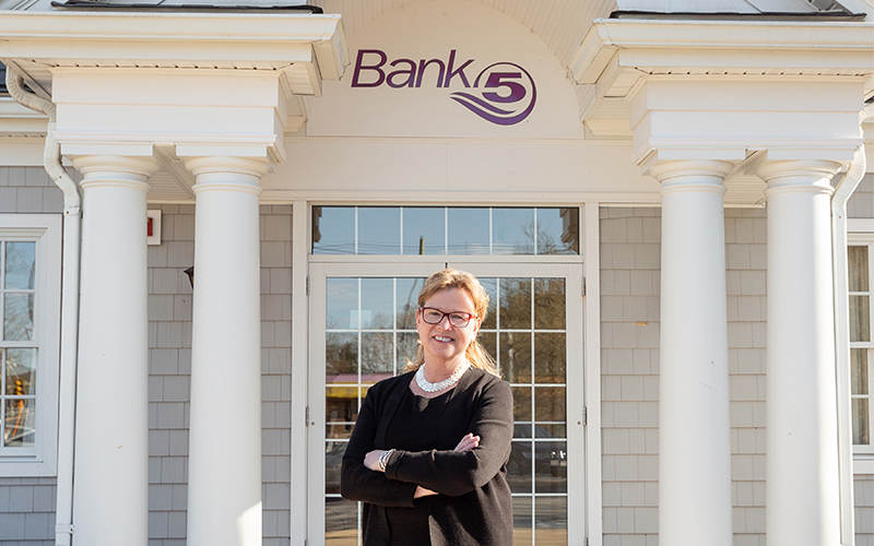 Anne Tangen in front of BankFive branch