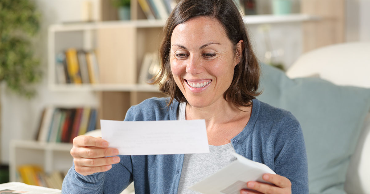 woman looking at tax refund check