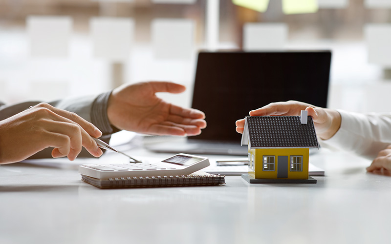 person signing loan handing over figurine home