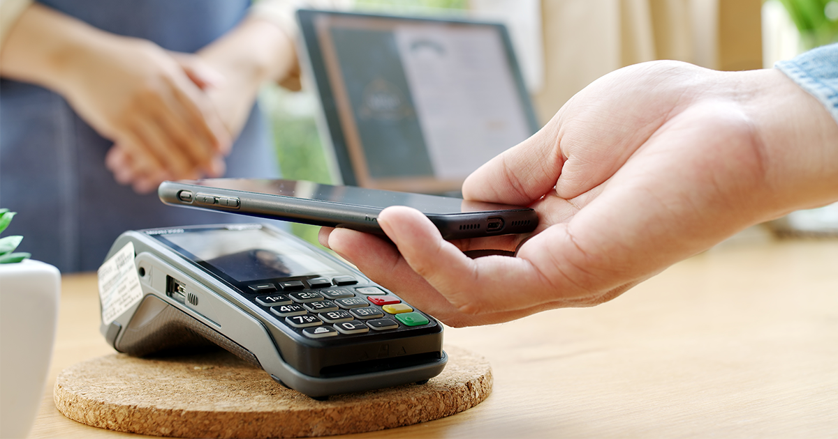 person paying with digital wallet on phone
