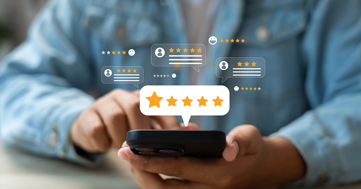 review icons around person holding cell phone