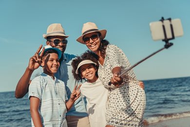 family on the beach taking a selfie