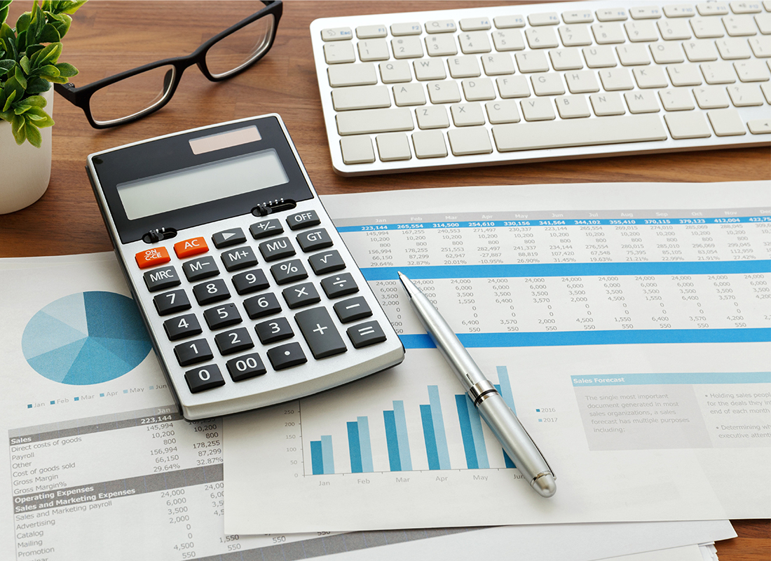 calculator on desk with financial statements