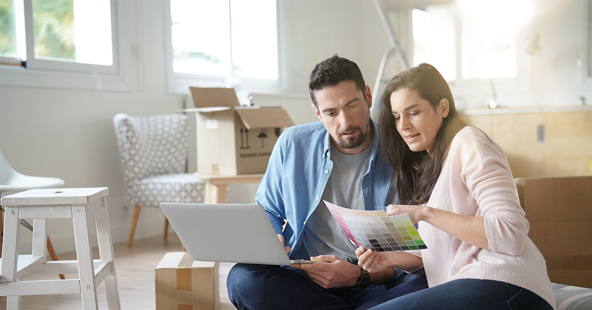 couple looking at paint options in new house