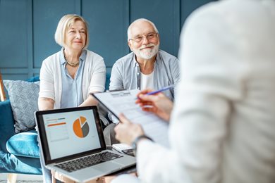 Elderly couple sitting with financial planner