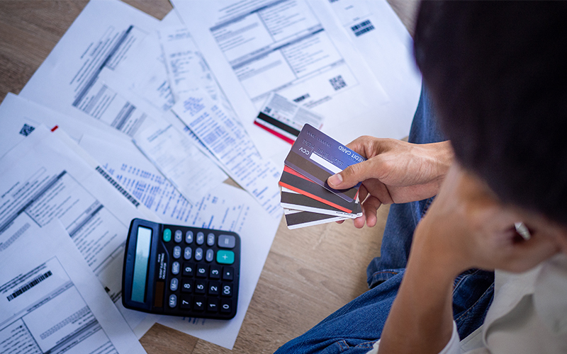 person analyzing bills and credit card options