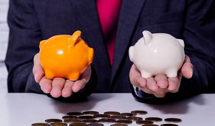 business man holding piggy bank in each hand