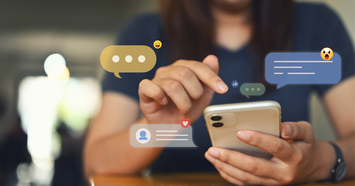 person on cell phone with like and comment icons 