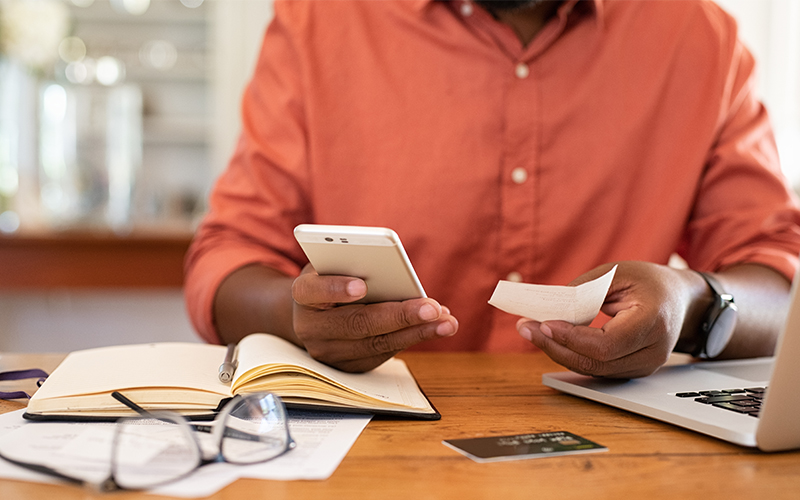 person checking finances on mobile phone