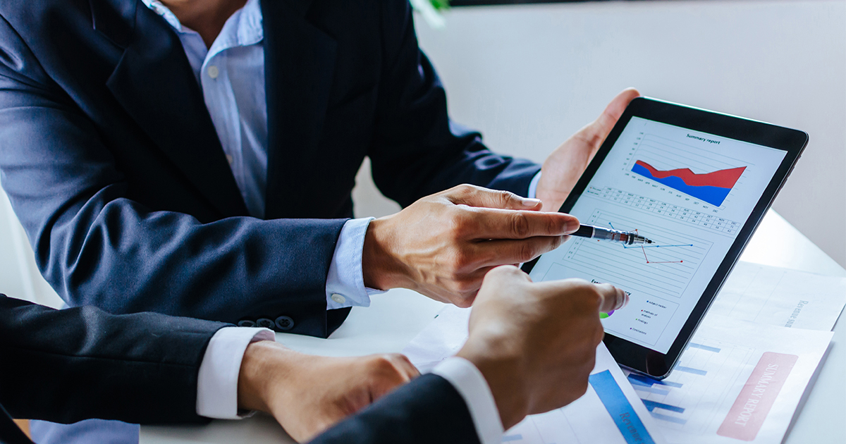 person reviewing investments on tablet