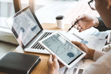 Two people looking at data on an ipad