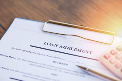 loan agreement paperwork and pen on a desk