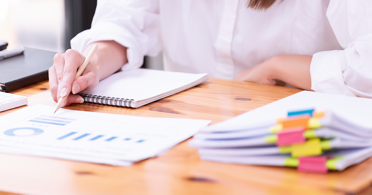person reviewing documents and taking notes