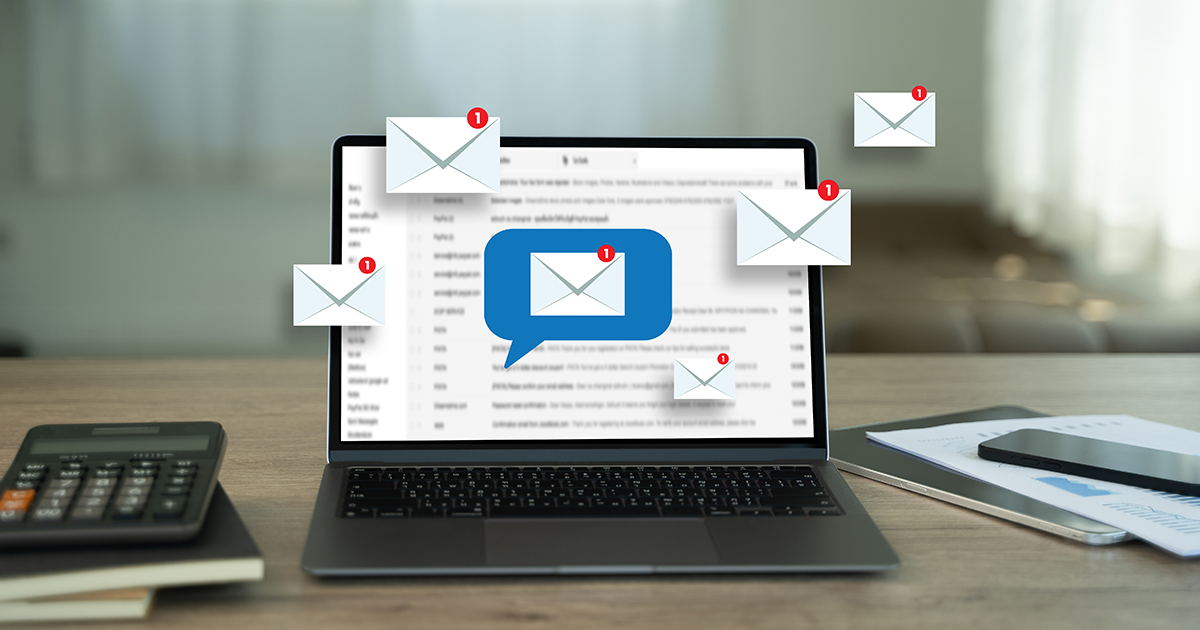 laptop with email icons surrounding 