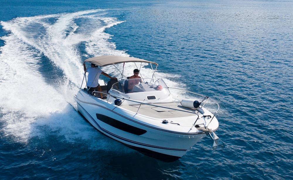 person driving a powerboat in the water