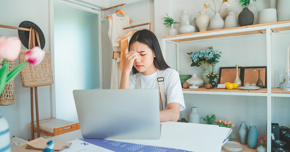 frustrated business owner looking at laptop