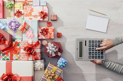 wrapped presents and person on calculator