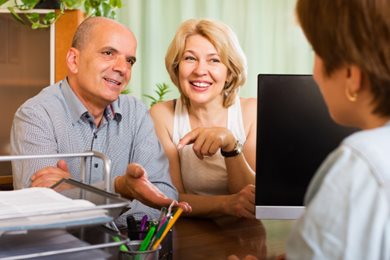 couple has a discussion at a desk with a banker